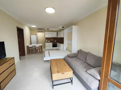 a living room with a couch and a table at Santa Marina Breeze in Sozopol