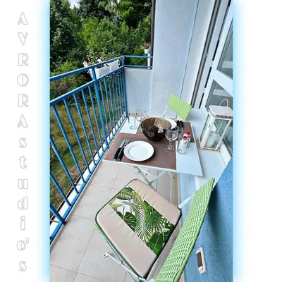 a balcony with a table and chairs on a balcony at Avrora Studio's in Byala