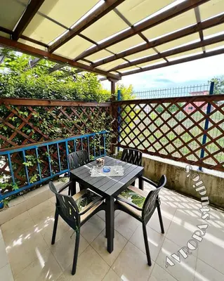 a black table and chairs on a patio at Avrora Studio's in Byala