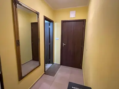 a hallway with a mirror and a wooden door at Elegant Studio near Beach - Terrace & Parking in Nesebar