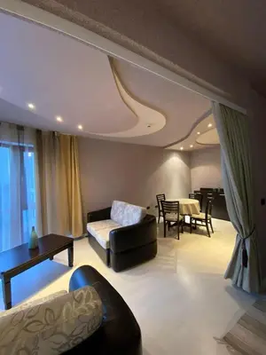 a living room with a couch and a table at Beautiful family appartment with sea view in Byala