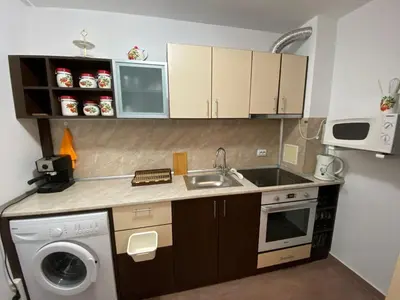 a small kitchen with a sink and a dishwasher at Beautiful family appartment with sea view in Byala