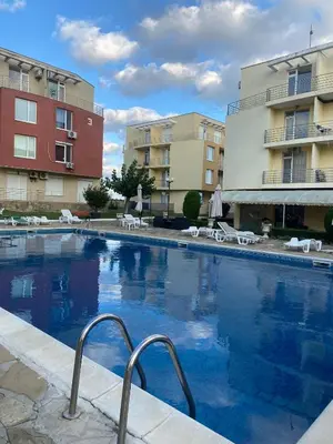 a large swimming pool next to two buildings at Sunny Day 5 in Tŭnkovo