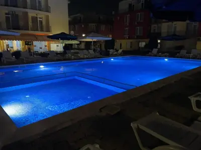 a large swimming pool with blue water at night at Sunny Day 5 in Tŭnkovo