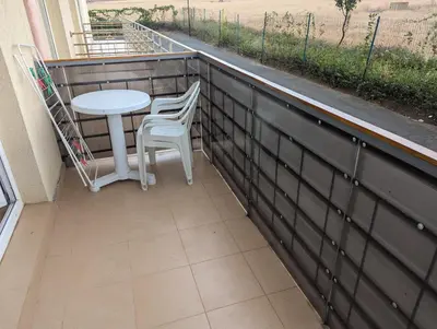 a small balcony with a table and two chairs at Sunny Day 5 in Tŭnkovo
