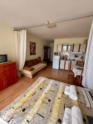 a living room with a bed and a kitchen at Imperial Fort Club Studio Apartment in Sveti Vlas
