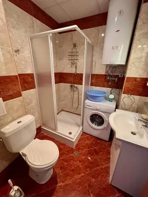 a bathroom with a shower and a toilet and a sink at Imperial Fort Club Studio Apartment in Sveti Vlas