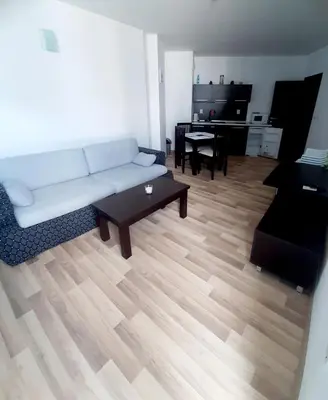 a living room with a white couch and a piano at Atlantis 8016 in Burgas City