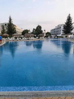 a large swimming pool with blue water in a resort at Atlantis 8016 in Burgas City