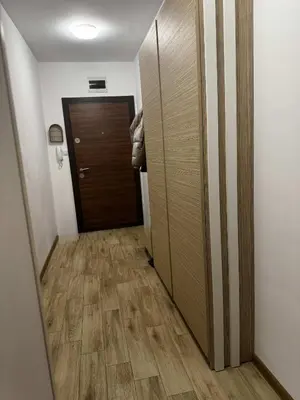 a hallway with a door leading to a room with wooden floors at 1BD Apartment next to the Sea Garden by Flat Mаnager in Burgas City