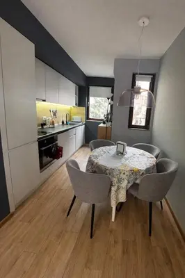 a kitchen and dining room with a table and chairs at 1BD Apartment next to the Sea Garden by Flat Mаnager in Burgas City