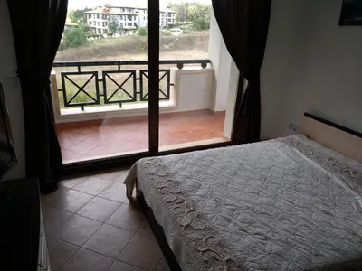 a bedroom with a bed and a view of a balcony at Oasis Resort&Spa Lozenets Studio 2 in Lozenets