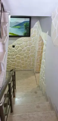a stairway with a tv on a wall at Морската Къща in Tsarevo