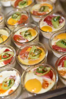 a bunch of small dishes with eggs and peppers at Villas Ropotamo Maisonette in Primorsko