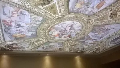 a ceiling with paintings on the ceilings of a building at Villa Roma Monna in Nesebar