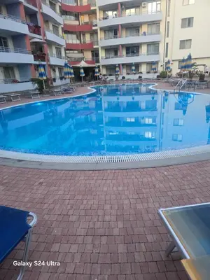 a large swimming pool in front of a building at Apartment in Central Plaza in Sunny Beach