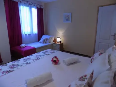 a bedroom with two beds with towels on them at Rali Apartments in Kiten