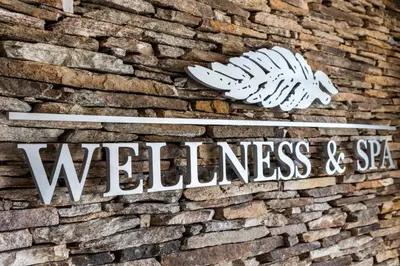 a sign on the side of a brick wall at Oasis Beach Club in Lozenets