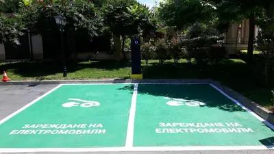 a green parking lot with a bike at Oasis Beach Club in Lozenets