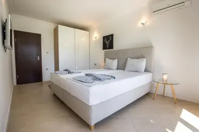 a bedroom with a large white bed in a room at Oasis Beach Club in Lozenets