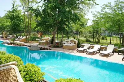 a swimming pool with chaise lounge chairs and a swimming pool at Harmony Suites - Dream Island in Sunny Beach