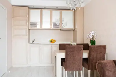 a kitchen with a dining room table with chairs at Harmony Suites - Dream Island in Sunny Beach