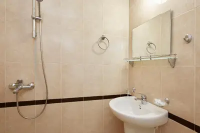 a bathroom with a toilet and a sink and a shower at Guesthouse Kirov in Ravda