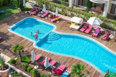 an overhead view of a swimming pool with people in chairs at Harmony Suites Saint Vlas in Sveti Vlas