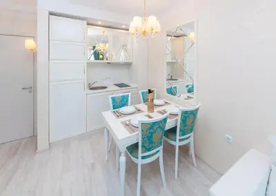 a kitchen and dining room with a table and chairs at Harmony Suites Saint Vlas in Sveti Vlas