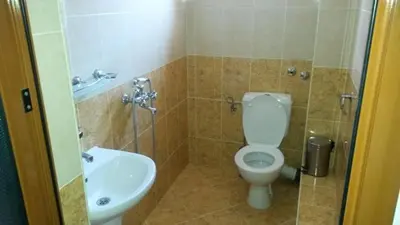 a bathroom with a toilet and a sink at Къща за гости Кадиеви in Primorsko