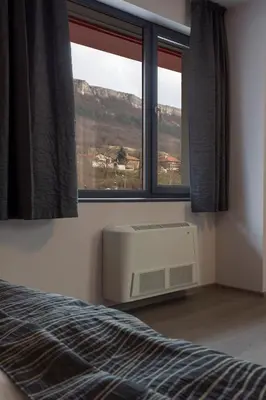 a bedroom with a bed and a window and a heater at Hotel Provadia in Provadiya