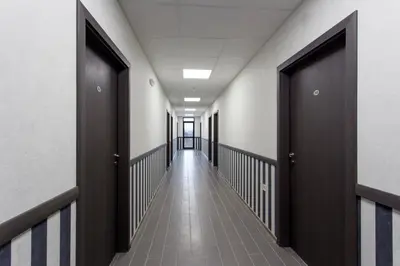 a corridor of an office building with wooden doors at Hotel Provadia in Provadiya