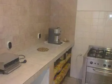 a kitchen with a counter with a coffee maker on it at Guest House Olimpiya in Sveti Vlas
