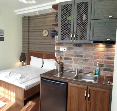 a kitchen with a sink and a bed in a room at Guest Rooms Maria Luiza in Varna City
