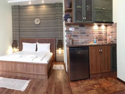 a bedroom with a bed and a kitchen with a sink at Guest Rooms Maria Luiza in Varna City