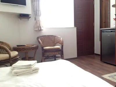 a room with chairs and a table with towels at Guest Rooms Maria Luiza in Varna City