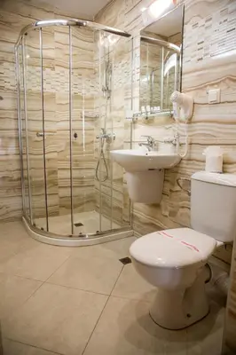 a bathroom with a toilet and a sink and a shower at Melia Mar in Sozopol