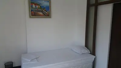 a bed in a room with a picture on the wall at Central Beach GUEST ROOMS in Burgas City