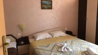 a bedroom with a bed with two towels on it at Apartments Dani in Pomorie