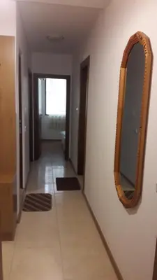 a hallway with a mirror on a wall at Sea Bedroom Apartments in Nesebar