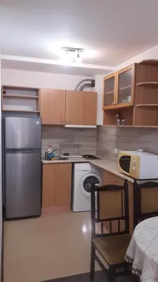 a kitchen with a stainless steel refrigerator and a dishwasher at Sea Bedroom Apartments in Nesebar