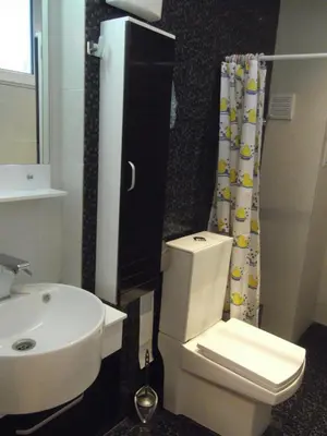 a bathroom with a white toilet and a sink at Apartment Sredna Gora in Burgas City