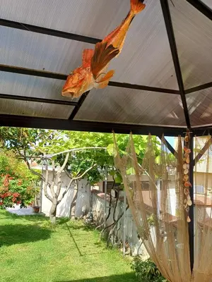 a bird decoration hanging from a pergola at Dom Zaharievi in Byala