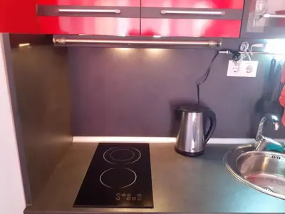 a kitchen counter with a stove and a sink at Studio Nera in Pomorie