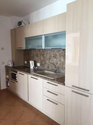 a kitchen with white cabinets and a sink at Apartments Bellevue in Ravda