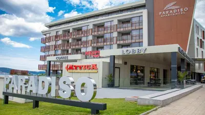 a large sign in front of a building at Aparthotel Paradiso in Nesebar