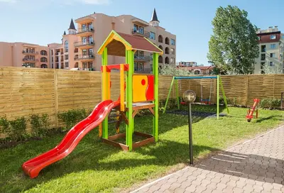 a playground with a slide in the grass at Calypso Hotel - All Inclusive in Sunny Beach