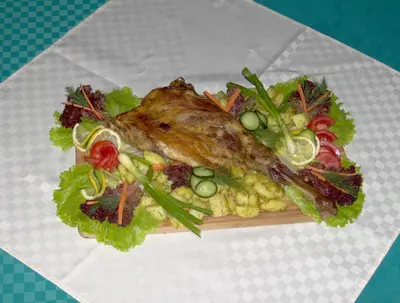 a plate of food with a fish and a salad at Hotel Eos in Kiten