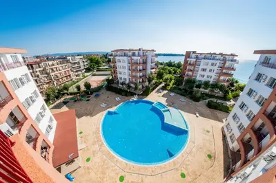 an overhead view of a swimming pool in the middle of buildings at Riviera Fort Beach Apartments in Ravda