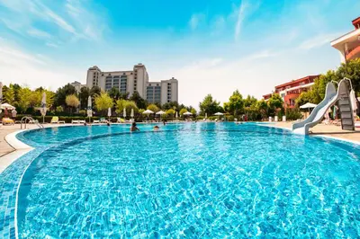 a large swimming pool in a city with buildings at Green Fort Noks Apartments in Sunny Beach